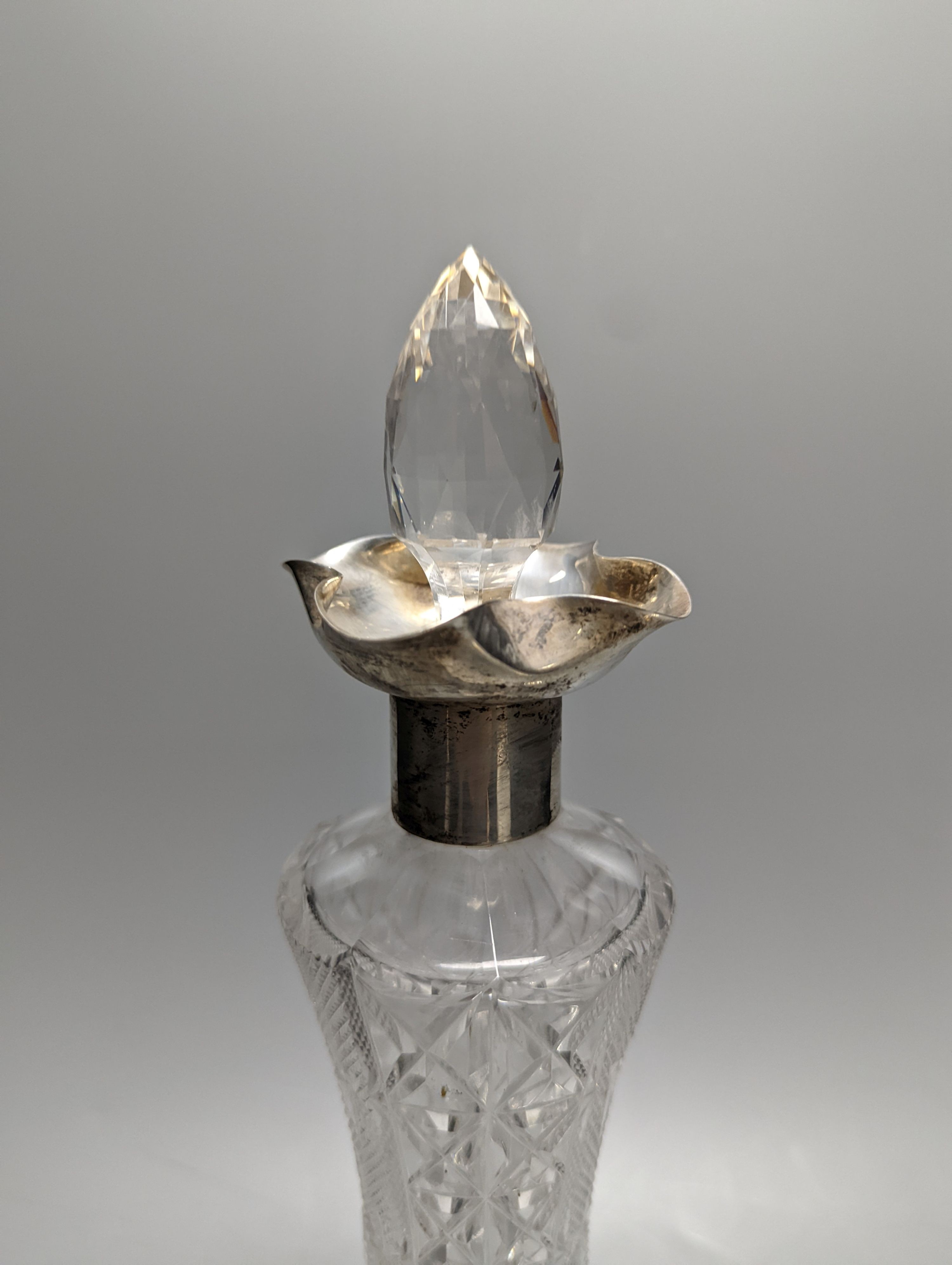 An Edwardian silver mounted cut glass decanter, Sheffield, 1903, 36cm and silver mounted pepper mill.